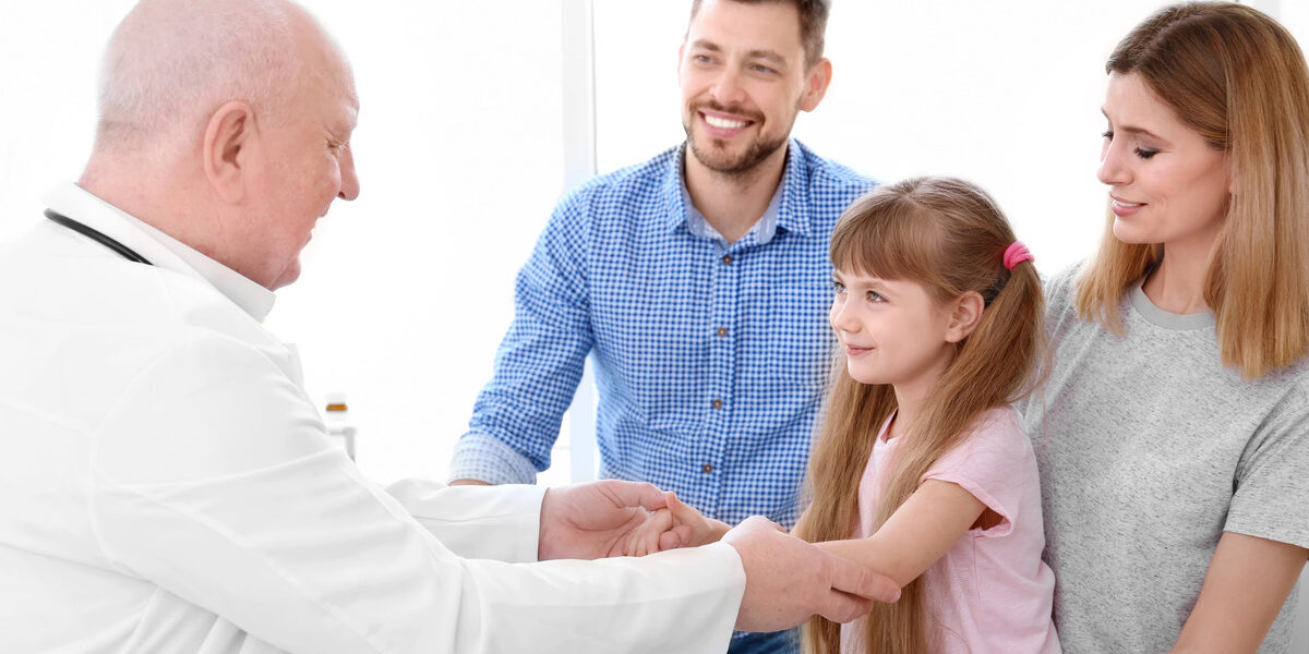 parents taking their daughter to a well child visit